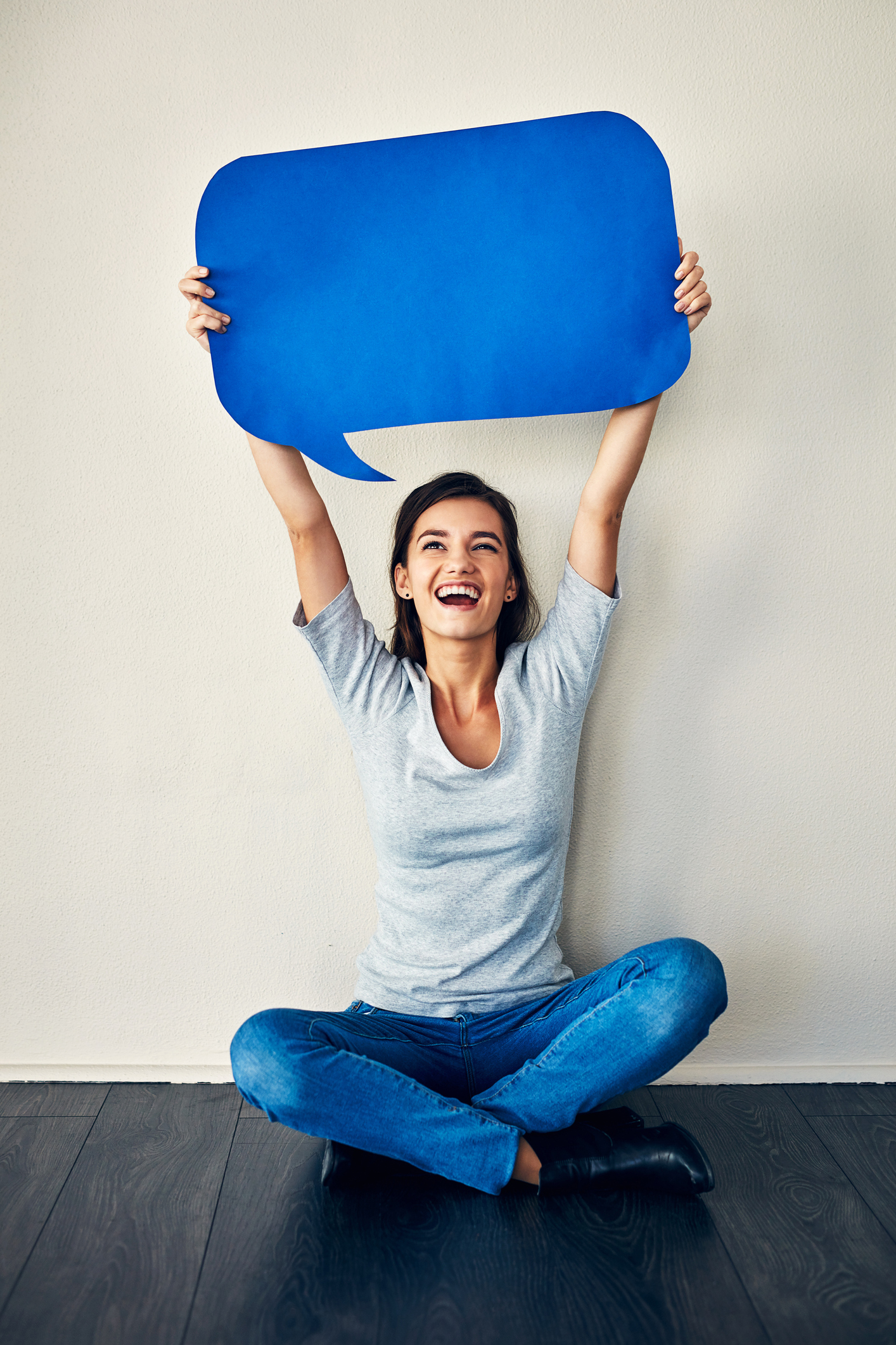 Studio shot of an attractive young woman posing against a grey background